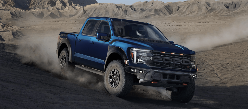 Blue 2025 Ford F-150 Raptor driving in the sand